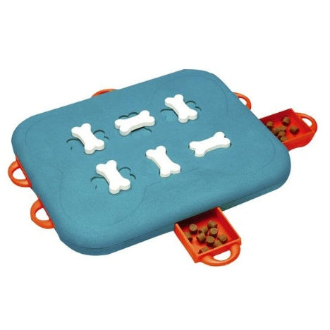 Dog playing with treat dispensing puzzle toy