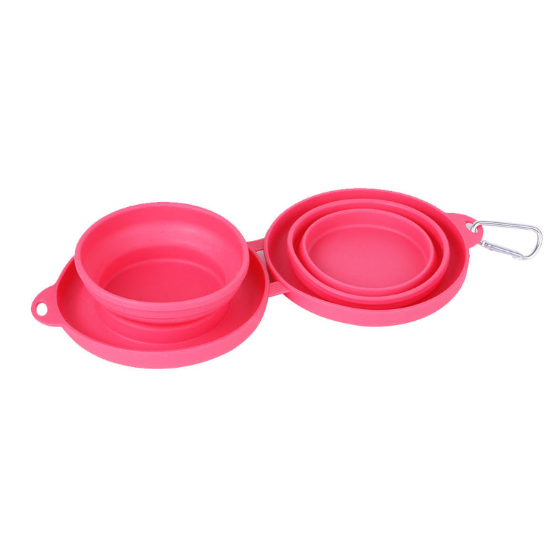 Pink collapsible travel bowls with carrying strap on a white background